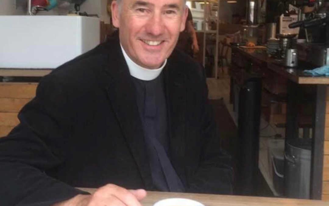 Image of Brian Hurst at a café with a coffee